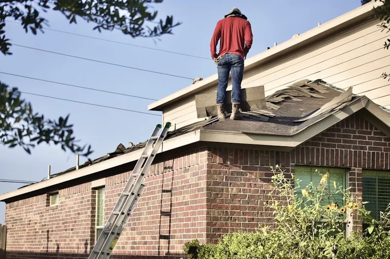 Professional roofer working on a residential roof in Plymouth Meadows
